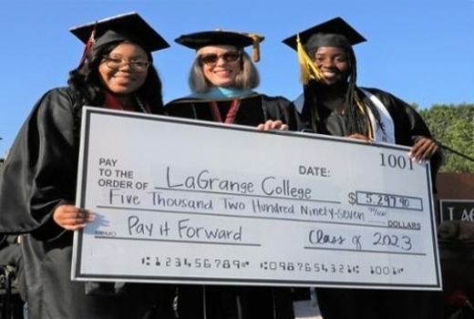 Seniors presenting check at commencement